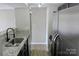 The updated kitchen features granite countertops, stainless steel appliances, and a sink with black faucet at 1604 Arlyn Cir # E, Charlotte, NC 28213