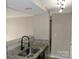 Bright kitchen featuring granite countertops, stainless steel dishwasher, and a black faucet at 1604 Arlyn Cir # E, Charlotte, NC 28213