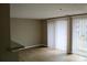 Bright Living Room with wood floors and sliding glass doors at 1604 Arlyn Cir # E, Charlotte, NC 28213