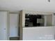 Bright living area with an open layout and view into the kitchen with stainless appliances at 1604 Arlyn Cir # E, Charlotte, NC 28213