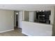 Open living space with laminate floors and view of the kitchen with granite countertops at 1604 Arlyn Cir # E, Charlotte, NC 28213