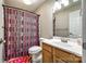 Bright bathroom featuring a shower with a patterned curtain, toilet, and vanity with a sink at 1648 Jonesberry Dr, Rock Hill, SC 29732