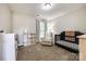 Neutral-toned Bedroom with a dark crib, cozy armchair, and storage shelves, bathed in natural light at 1648 Jonesberry Dr, Rock Hill, SC 29732