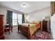 Cozy bedroom featuring a wooden bed frame, colorful rug, and bright window with decorative curtains at 1648 Jonesberry Dr, Rock Hill, SC 29732
