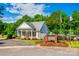 Community clubhouse surrounded by green landscaping, signage, and an American flag on a sunny day at 1648 Jonesberry Dr, Rock Hill, SC 29732