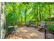 Back deck surrounded by lush greenery, featuring patio furniture perfect for enjoying the outdoors at 1648 Jonesberry Dr, Rock Hill, SC 29732