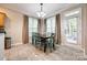 Bright dining area with tiled floors, a stylish chandelier, and ample natural light at 1648 Jonesberry Dr, Rock Hill, SC 29732