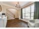Bright dining room featuring hardwood floors, large window, and elegant chandelier at 1648 Jonesberry Dr, Rock Hill, SC 29732