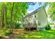 Two-story house exterior with a wooden deck in the backyard surrounded by green grass and trees at 1648 Jonesberry Dr, Rock Hill, SC 29732