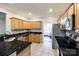 Modern kitchen with granite countertops, wooden cabinets, and stainless steel appliances at 1648 Jonesberry Dr, Rock Hill, SC 29732