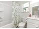 Bright bathroom with a shower-tub combo, decorative shower curtain, and vanity with a mirror and sink at 1659 Loggerhead Dr, Lancaster, SC 29720