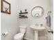 Clean half-bathroom features pedestal sink, round mirror, and decorative shelves at 1659 Loggerhead Dr, Lancaster, SC 29720