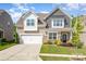Charming two-story home with a manicured lawn, lovely landscaping, and a two-car garage at 1659 Loggerhead Dr, Lancaster, SC 29720