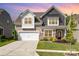 Charming two-story home with a manicured lawn, mature trees, and a welcoming entrance; perfect for families at 1659 Loggerhead Dr, Lancaster, SC 29720