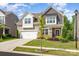 Well-maintained two-story home with manicured landscaping, a tree-lined yard, and a welcoming facade at 1659 Loggerhead Dr, Lancaster, SC 29720