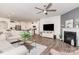 Open-concept living room boasts a ceiling fan, fireplace, and flows into the modern kitchen at 1659 Loggerhead Dr, Lancaster, SC 29720