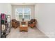 Cozy sitting area with a window, comfortable wicker chairs, and a small table for relaxing or reading at 1659 Loggerhead Dr, Lancaster, SC 29720