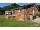 Backyard featuring a brick house, wooden deck, grassy yard and blue skies at 1735 Hollandale Dr, Gastonia, NC 28054