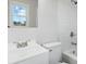 A clean white bathroom features a vanity, toilet, tub and shower at 1735 Hollandale Dr, Gastonia, NC 28054