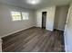 Bright bedroom featuring wood-look flooring, closet, and a window offering plenty of natural light at 1735 Hollandale Dr, Gastonia, NC 28054