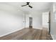 A neutral-toned bedroom features a fan, closet, and en-suite bathroom at 1735 Hollandale Dr, Gastonia, NC 28054