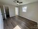 Bedroom featuring wood-look floors, ceiling fan, closet, natural light, and neutral walls at 1735 Hollandale Dr, Gastonia, NC 28054