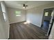 Bedroom featuring wood-look floors and natural light from two windows and neutral walls at 1735 Hollandale Dr, Gastonia, NC 28054