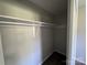 This closet features a bar for hanging clothes and light neutral walls at 1735 Hollandale Dr, Gastonia, NC 28054