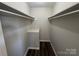 This closet features bars for hanging clothes and light neutral walls at 1735 Hollandale Dr, Gastonia, NC 28054