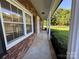 Charming exterior elevation featuring red brick, white pillars and trimmed bushes at 1735 Hollandale Dr, Gastonia, NC 28054