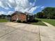 Exterior elevation featuring a red brick house, well manicured yard and paved driveway at 1735 Hollandale Dr, Gastonia, NC 28054