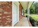 A brick home's entrance features a covered porch and white front door at 1735 Hollandale Dr, Gastonia, NC 28054