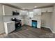 Modern kitchen with white cabinets, stainless steel appliances, subway tile backsplash, and stylish blue dishwasher at 1735 Hollandale Dr, Gastonia, NC 28054