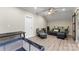 Spacious basement area featuring light floors, comfortable seating, and a modern desk area at 19004 Dry Narrows Way, Charlotte, NC 28278