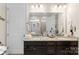 Bathroom featuring double sinks, granite countertops and ample storage space in dark wood cabinets at 19004 Dry Narrows Way, Charlotte, NC 28278