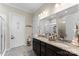 Bathroom featuring double sinks, granite countertops and ample storage space in dark wood cabinets at 19004 Dry Narrows Way, Charlotte, NC 28278