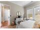 Bright bedroom featuring large window, white dresser with round mirror, and comfortable bedding at 19004 Dry Narrows Way, Charlotte, NC 28278