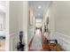 Inviting hallway with wood floors, elegant wainscoting, and tasteful decor at 19004 Dry Narrows Way, Charlotte, NC 28278