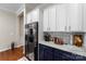 Contemporary kitchen with sleek appliances, white cabinets, and designer backsplash at 19004 Dry Narrows Way, Charlotte, NC 28278