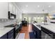 Modern kitchen with stainless steel appliances and open layout to dining area at 19004 Dry Narrows Way, Charlotte, NC 28278