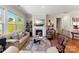 Inviting living room with a fireplace and large windows providing natural light at 19004 Dry Narrows Way, Charlotte, NC 28278