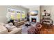 Cozy living room featuring a fireplace, large windows, and comfortable seating at 19004 Dry Narrows Way, Charlotte, NC 28278