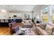Inviting living area with wood floors, a view to kitchen and a sun-filled dining nook at 19004 Dry Narrows Way, Charlotte, NC 28278