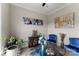 Cozy sitting room featuring blue velvet chairs, an elegant glass table, and unique decor at 19004 Dry Narrows Way, Charlotte, NC 28278