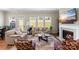 Cozy living room with a fireplace, hardwood floors, and comfortable seating area at 19004 Dry Narrows Way, Charlotte, NC 28278