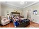 Spacious main bedroom features an adjacent bathroom and a comfortable seating area near the bed at 19004 Dry Narrows Way, Charlotte, NC 28278