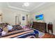 Spacious main bedroom features hardwood floors, a large television and doors to other rooms at 19004 Dry Narrows Way, Charlotte, NC 28278