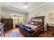 Spacious main bedroom features a trey ceiling, chandelier, hardwood floors and a window with outdoor views at 19004 Dry Narrows Way, Charlotte, NC 28278