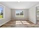 Bedroom with two windows and lots of light featuring new vinyl flooring and white trim at 2009 Auten Rd, Gastonia, NC 28054