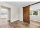 Neutral bedroom with a sliding barn door, and vinyl plank flooring at 2009 Auten Rd, Gastonia, NC 28054
